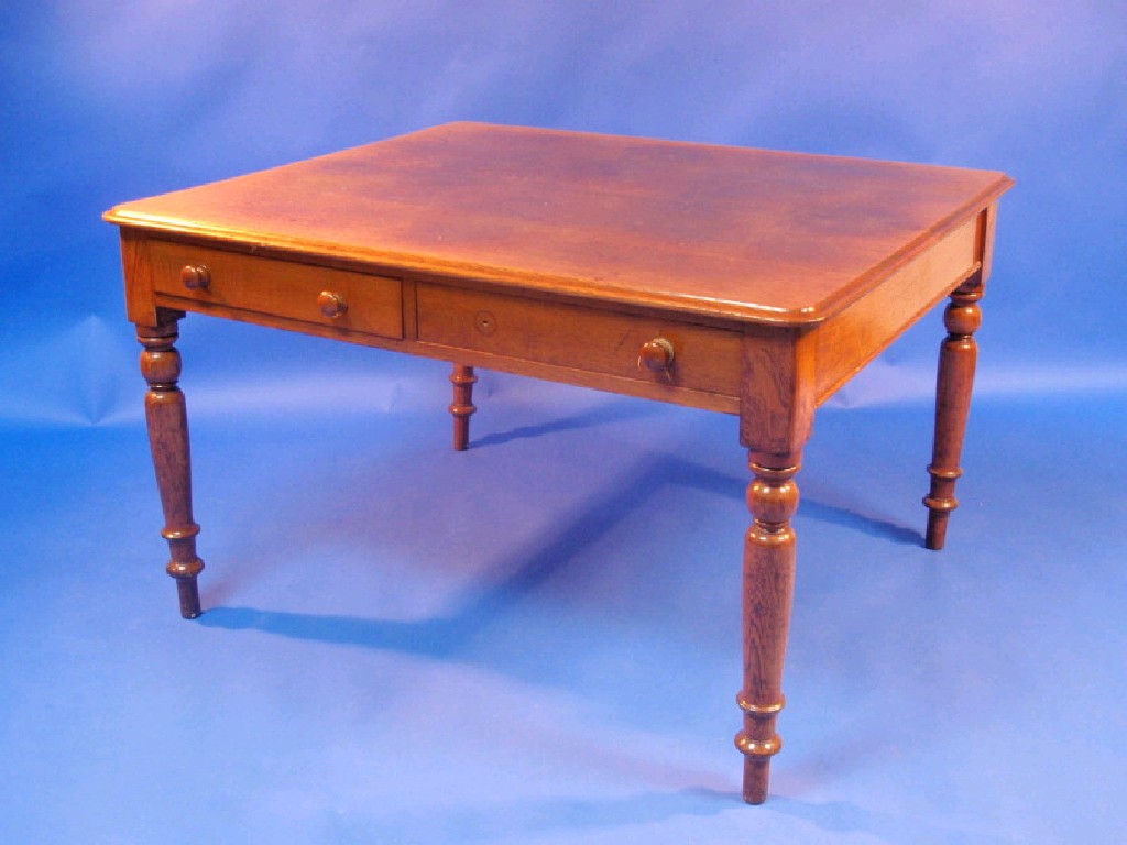 Appraisal: A Victorian oak library table with moulded top and opposing