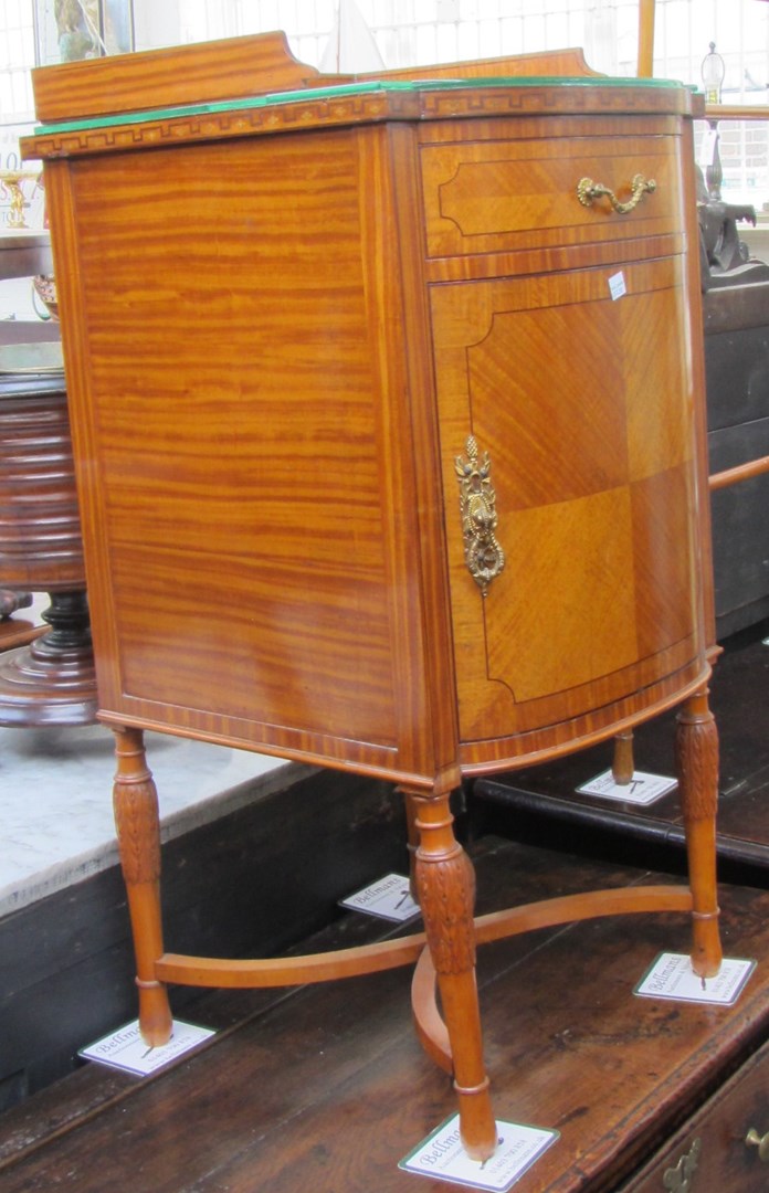 Appraisal: An early th century satinwood bowfront bedside table with single