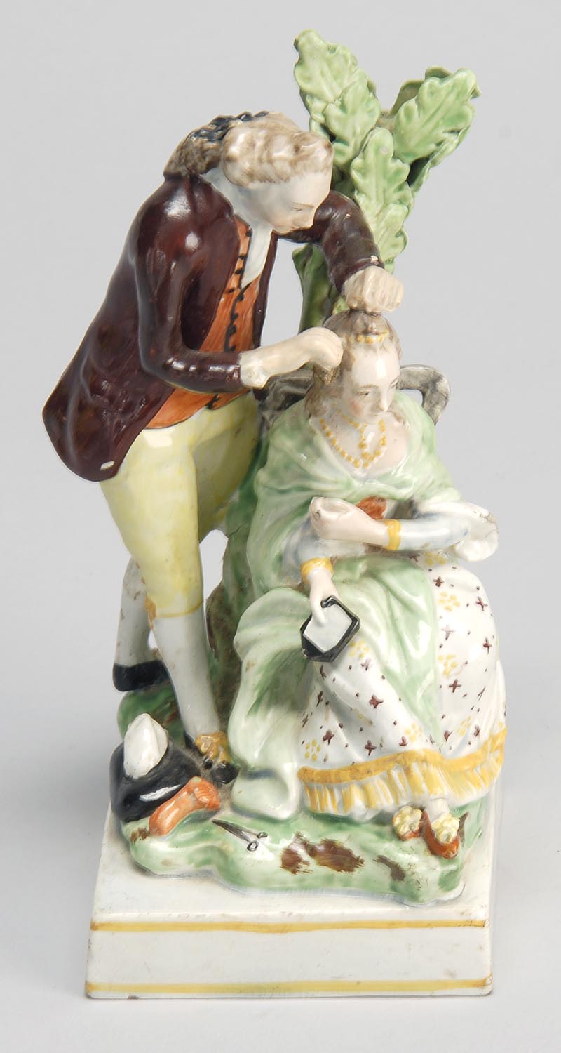 Appraisal: TH CENTURY ENGLISH STAFFORDSHIRE FIGURE of a male hairdresser and