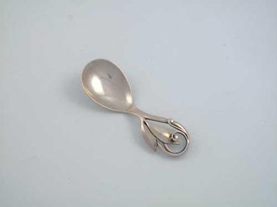 Appraisal: A modern Danish caddy spoon with a foliate and tendril