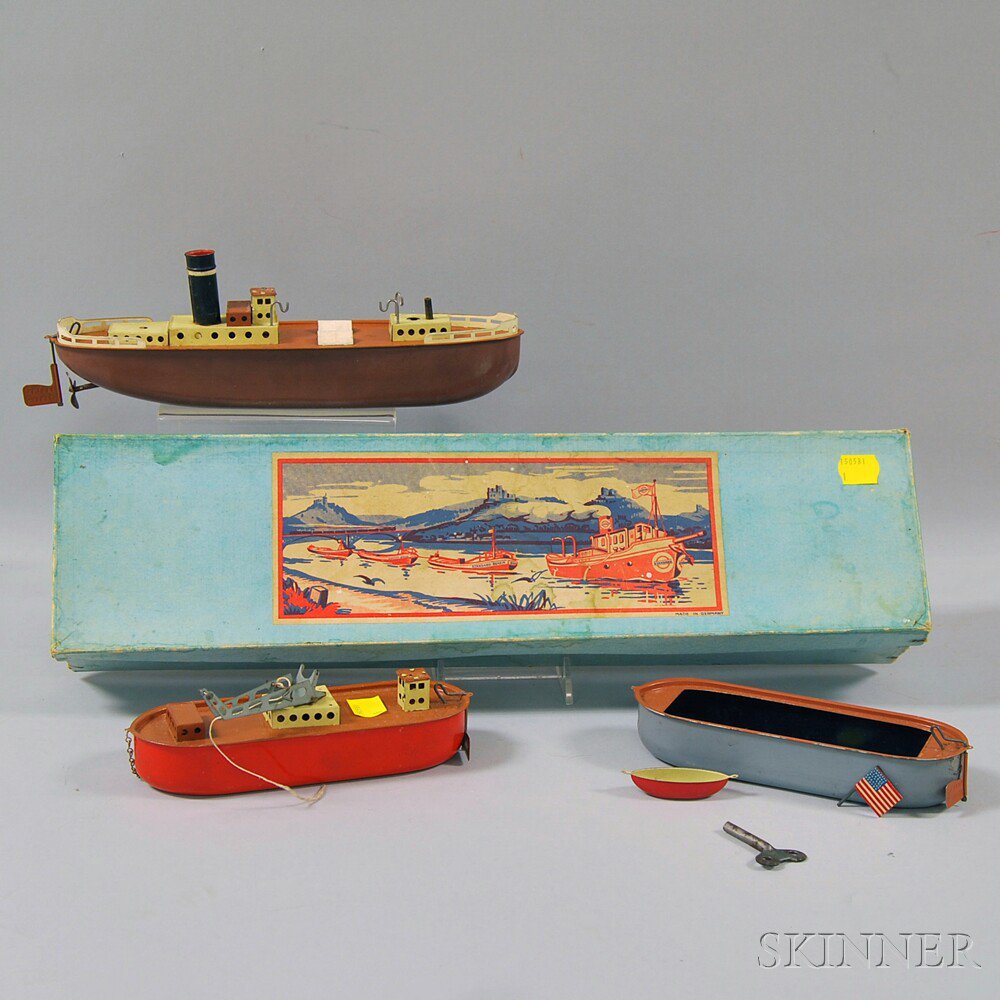 Appraisal: Three-piece Tin Clockwork Tugboat and Barge Set attributed to Gebruder