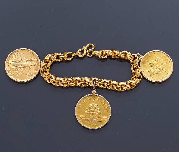 Appraisal: A twenty-four karat gold coin charm bracelet suspending three gold