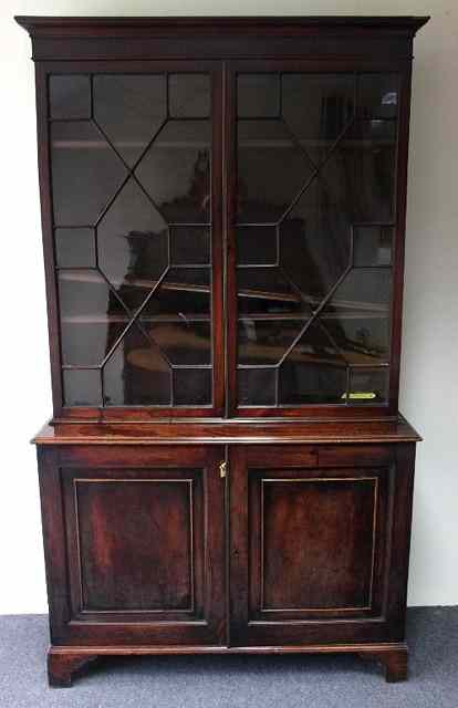 Appraisal: A George III mahogany bookcase fitted adjustable shelves enclosed by