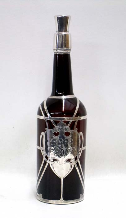 Appraisal: SILVER OVERLAY BOTTLE WITH STOPPER c having heraldic monogrammed label