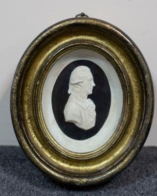 Appraisal: after John Flaxman - Plaster relief portrait of Dr Herschel