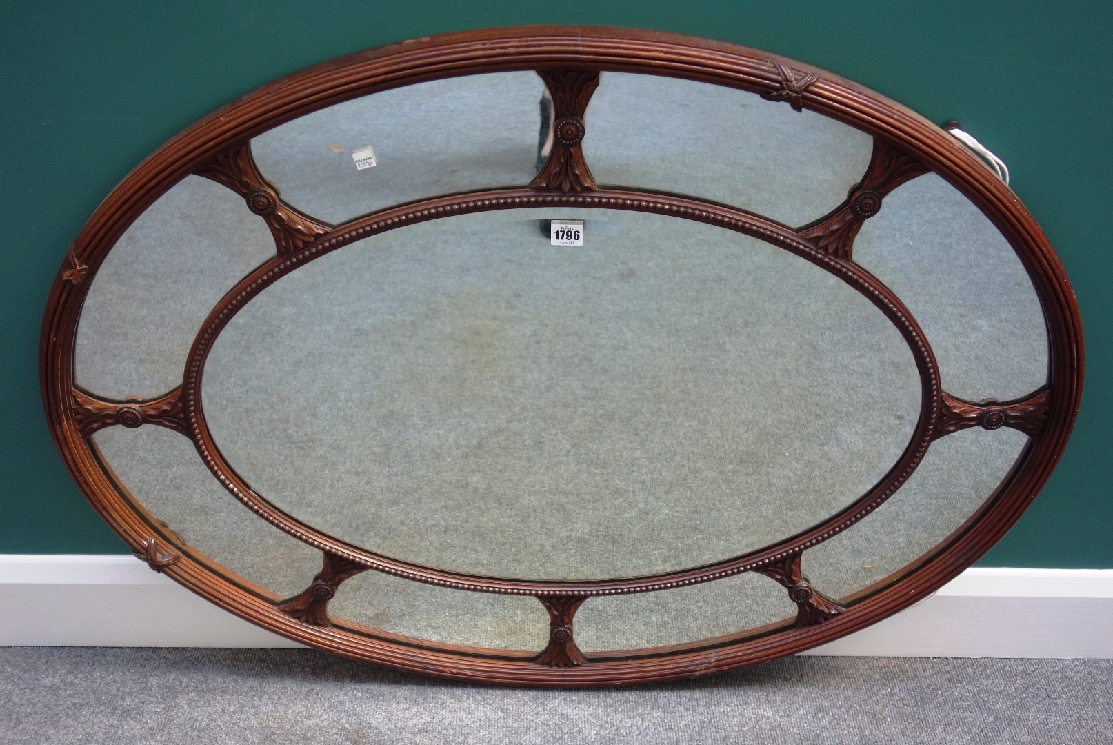 Appraisal: An th century style mahogany framed segmented oval wall mirror