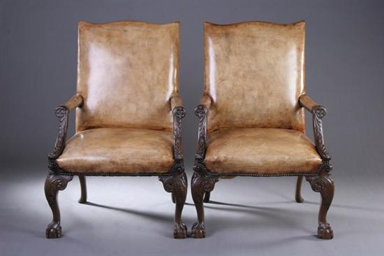 Appraisal: PAIR GEORGIAN STYLE MAHOGANY LIBRARY CHAIRS th century with nailed