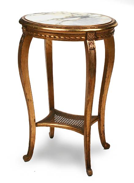 Appraisal: An oval carved and gilt table with a marble top