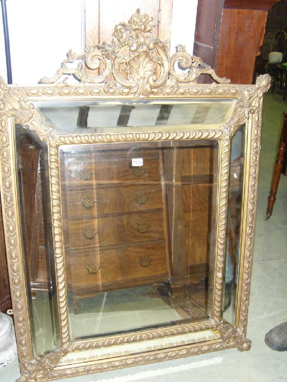 Appraisal: A th century wall mirror the cushioned frame enbclosing bevel