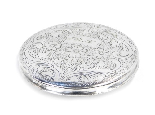 Appraisal: A circular compact white metal engraved with flowers and scrolling