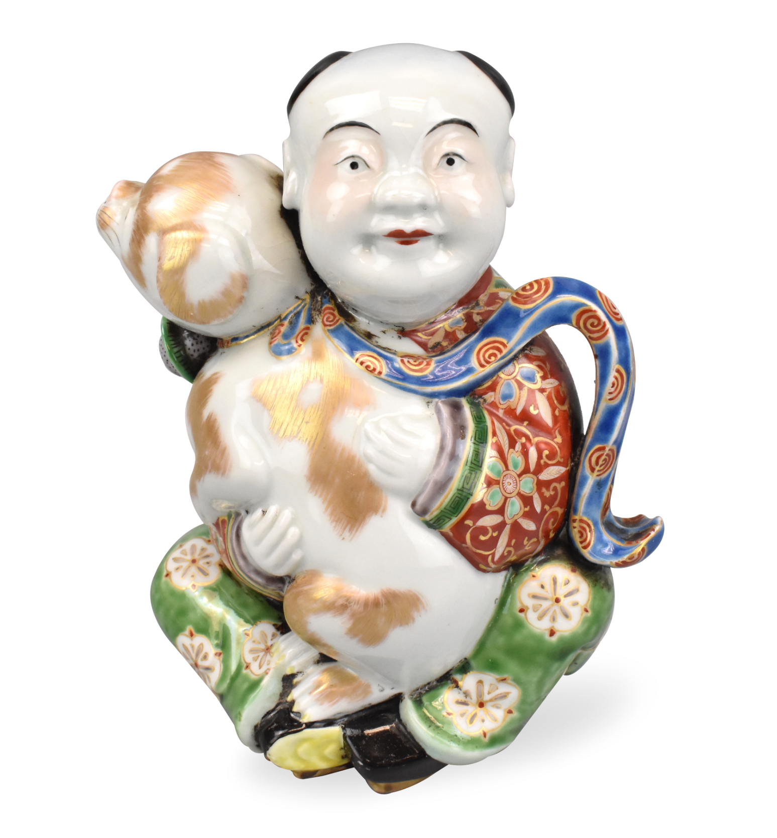 Appraisal: A Japanese porcelain figure of a sitting boy holding a