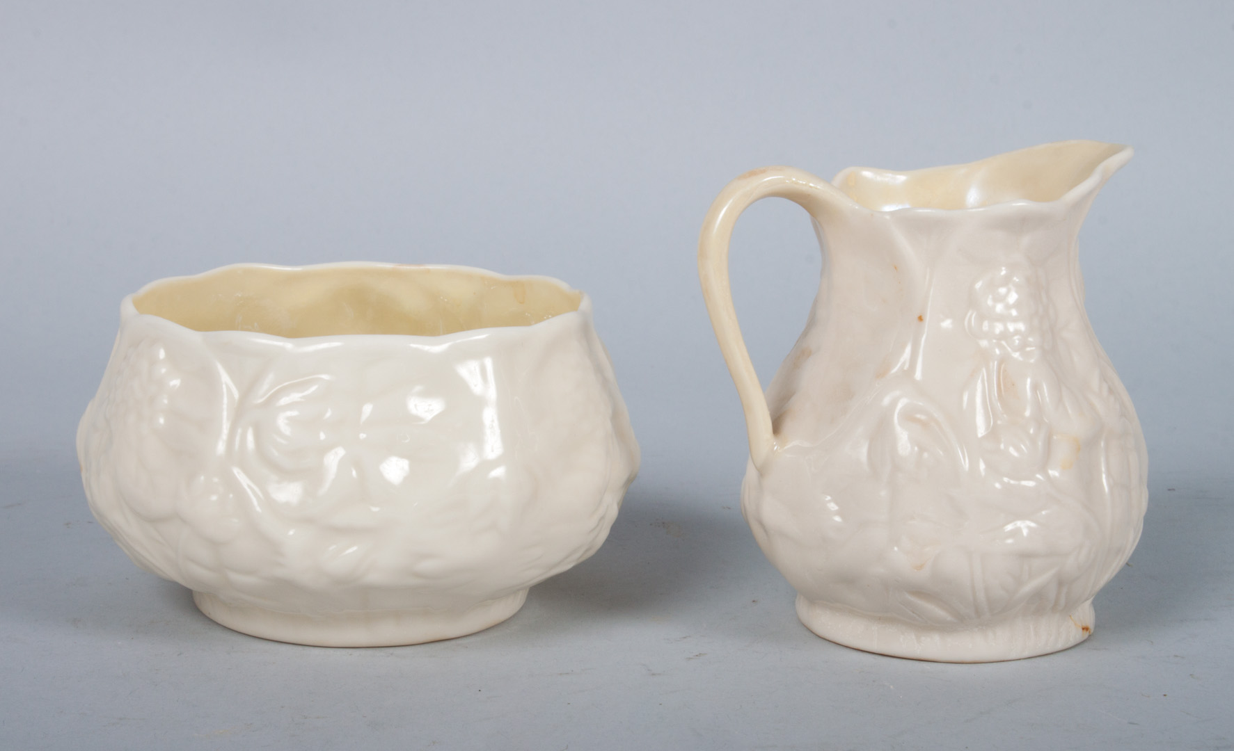 Appraisal: Belleek cream jug and sugar bowl glazed parianware with floral