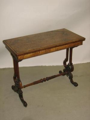 Appraisal: A VICTORIAN WALNUT FOLDING TEA TABLE of rounded oblong form