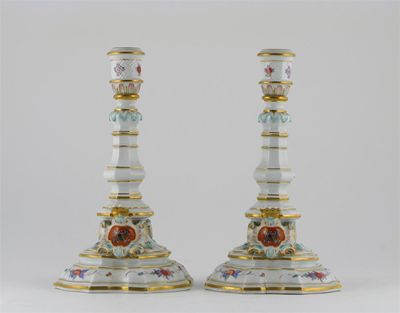 Appraisal: A pair of Meissen armorial candlesticks moulded with facets and