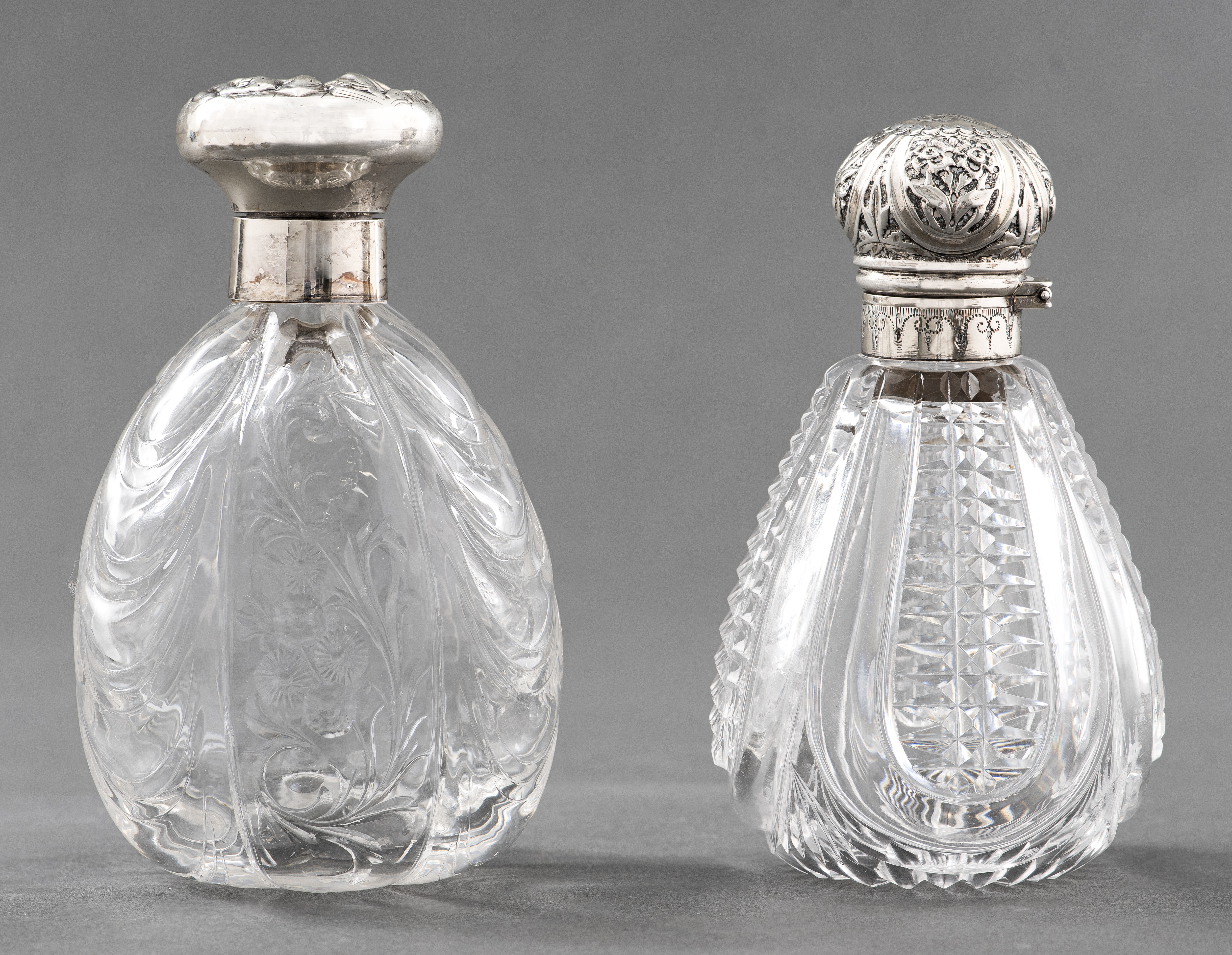 Appraisal: EDWARDIAN STERLING SILVER GLASS PERFUME BOTTLES English Edwardian pair of