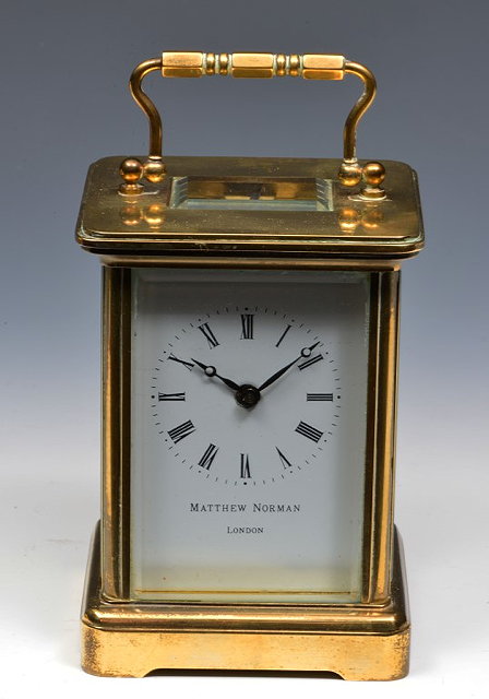 Appraisal: A MATTHEW NORMAN BRASS CARRIAGE TIMEPIECE with white enamel Roman