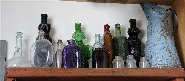 Appraisal: FOURTEEN GLASS BOTTLES AND FLASKS Including two bear figural bottles