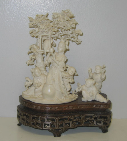 Appraisal: CHINESE CARVED IVORY FIGURE GROUP Depicting a woman with four