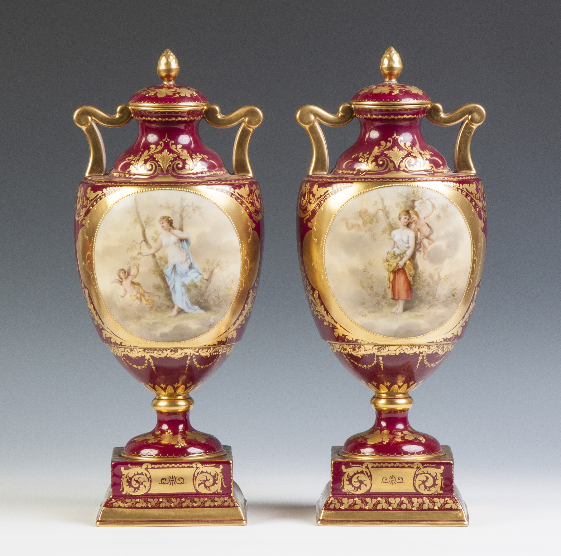 Appraisal: Pair of Hand Painted Vienna Urns th cent Depicting young