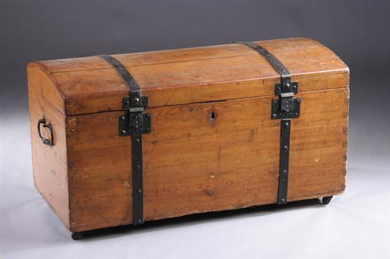 Appraisal: PINE DOMED TRUNK th century Dovetailed case with wrought-iron fittings