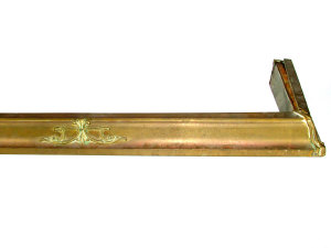 Appraisal: An Edwardian brass fender with applied mounts length cm a