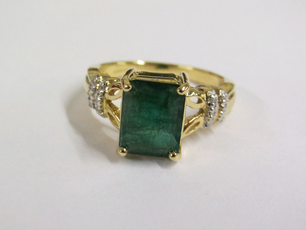 Appraisal: Eighteen carat gold step cut emerald set ring with diamond