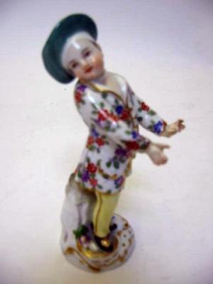 Appraisal: A MEISSEN PORCELAIN FIGURE OF A CHILD wearing a green