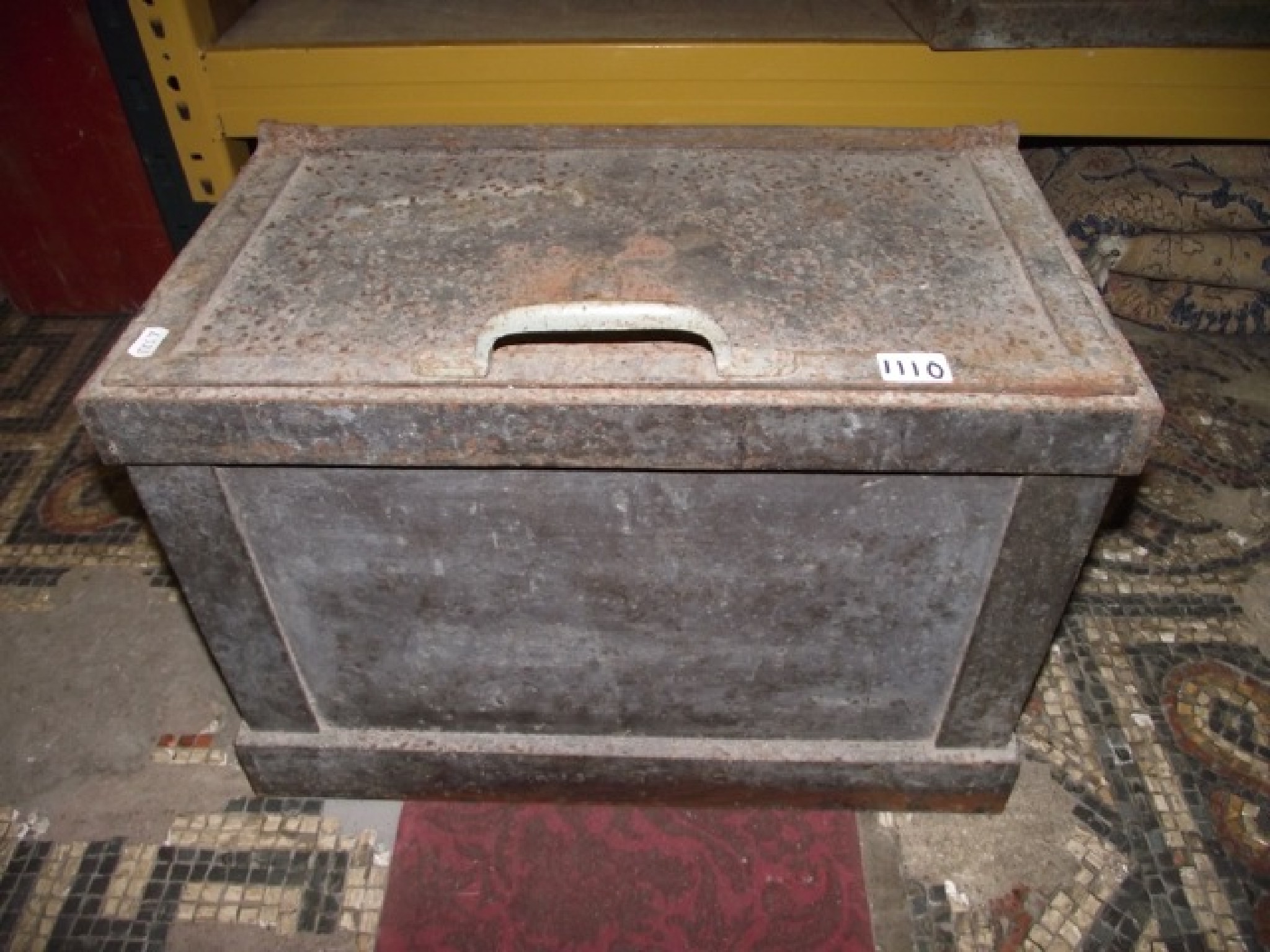 Appraisal: A simple vintage cast iron strongbox safe with side carrying