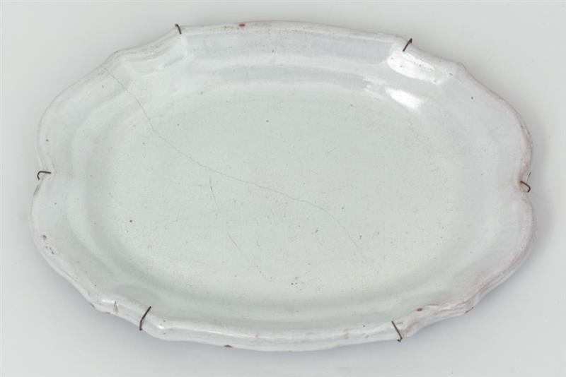 Appraisal: Two French Ivory-Glazed Faience Platters One impressed Olivier Paris on