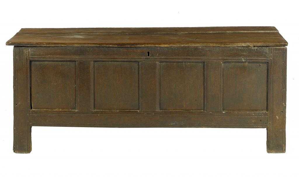 Appraisal: A JOINED OAK CHEST with boarded lid back and four-panel