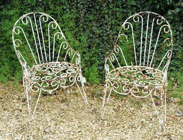 Appraisal: A PAIR OF OLD PAINTED WROUGHT IRON GARDEN ARMCHAIRS frames