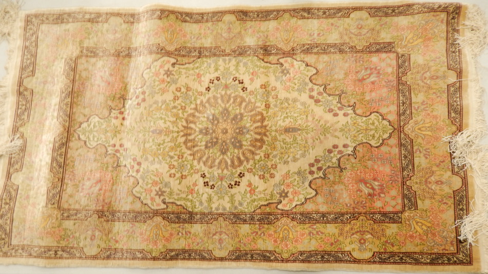 Appraisal: A thC silk Qum rug a central medallion decorated overall