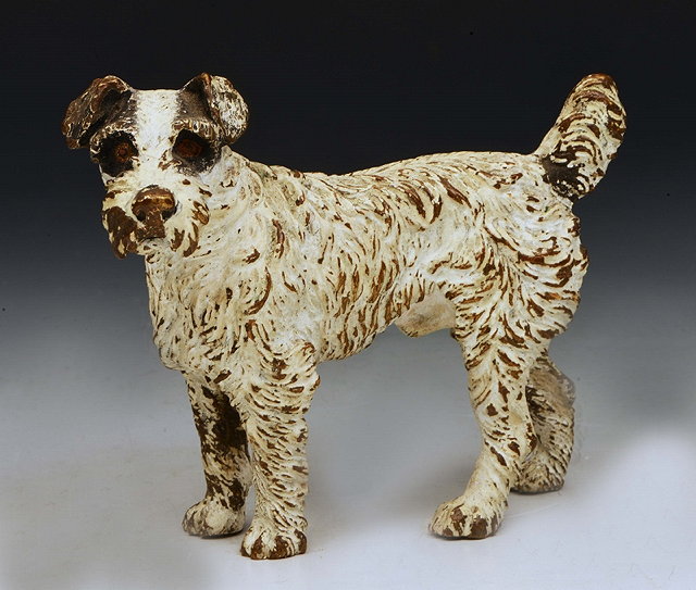 Appraisal: AN COLD CAST BRONZE MODEL of a terrier with white