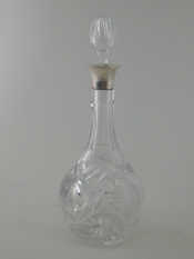 Appraisal: A silver-mounted cut-glass decanter detachable stopper sides cut with flowers