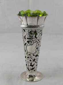 Appraisal: A pierced silver vase with green glass liner cm high