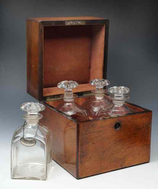 Appraisal: A VICTORIAN ROSEWOOD DECANTER BOX with four original decanters and