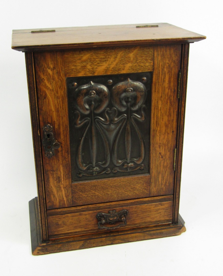 Appraisal: A Victorian Art Nouveau oak and copper smoker's cabinet the