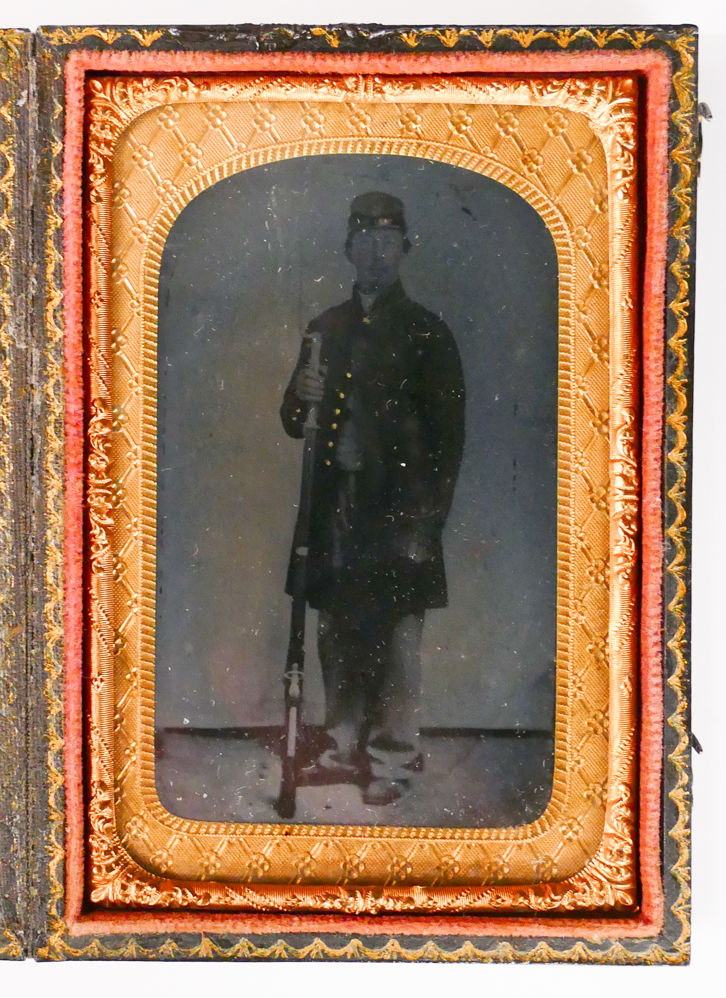 Appraisal: CDV Size Tintype Portrait of Soldier with Rifle Plate measures