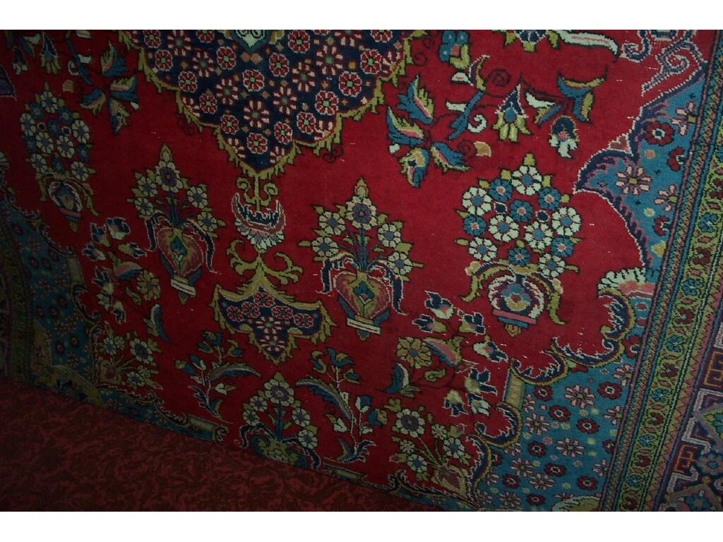 Appraisal: A red ground wool carpet in the Persian style with