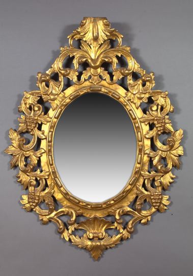 Appraisal: Large Oval Italian Carved Giltwood Looking Glass in the th-century