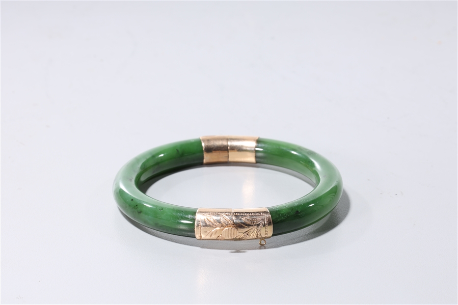 Appraisal: Chinese spinach jade and k gold mounted cut bangle interior