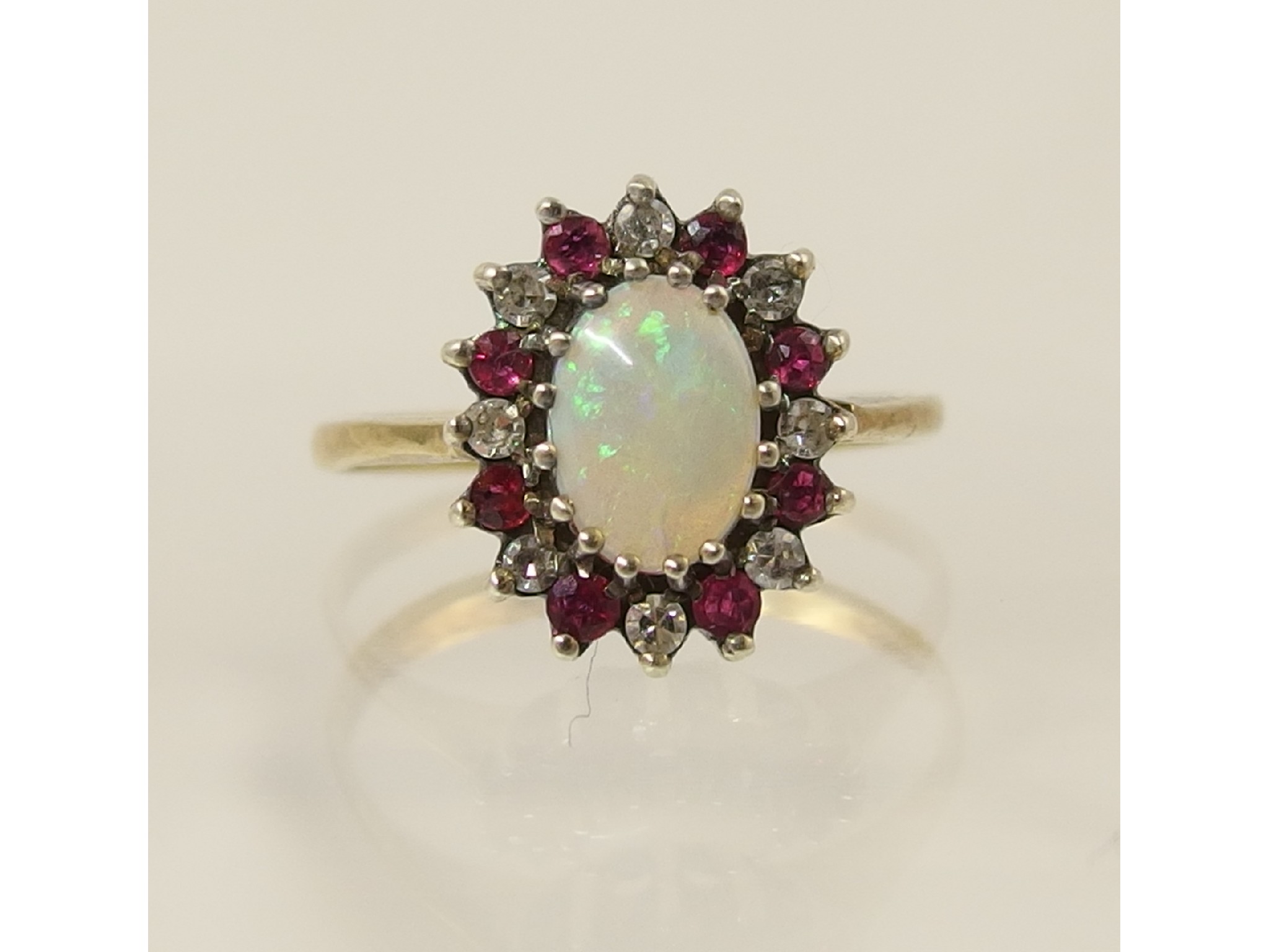 Appraisal: A ct opal diamond and ruby cluster ring