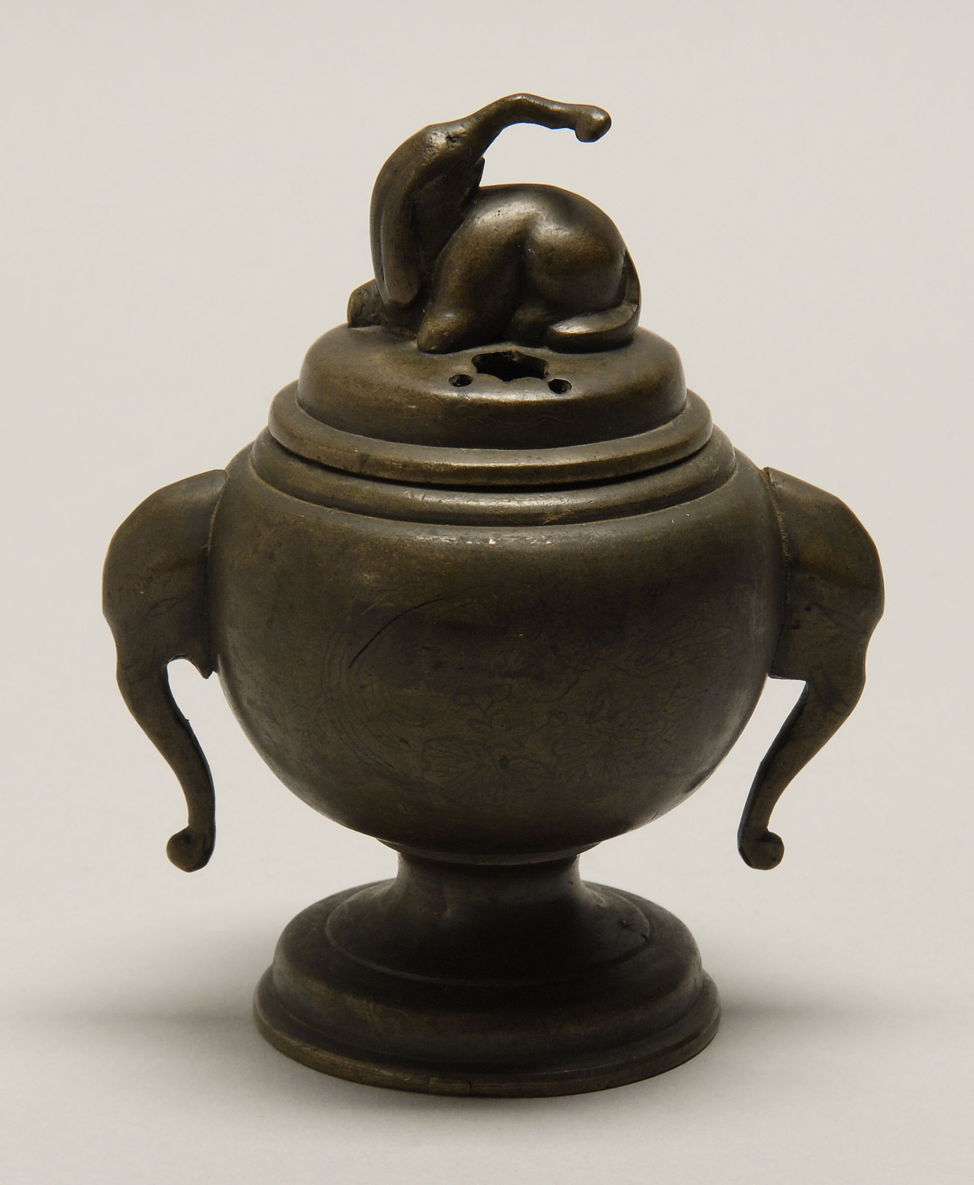 Appraisal: BRONZE CENSER th CenturyIn baluster form with elephant's-head handles Domed