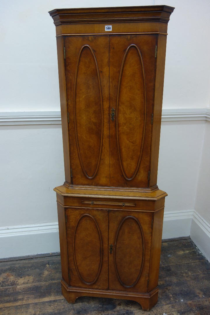 Appraisal: A reproduction mahogany and burr veneered floor standing corner drinks