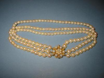 Appraisal: A CULTURED PEARL CHOKER comprising three strands of graduated beads