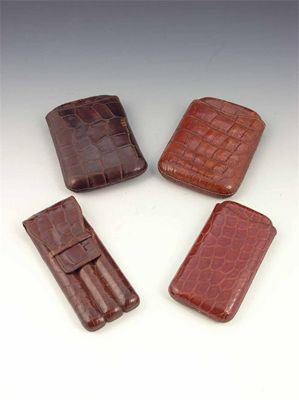 Appraisal: Four crocodile cigar cases