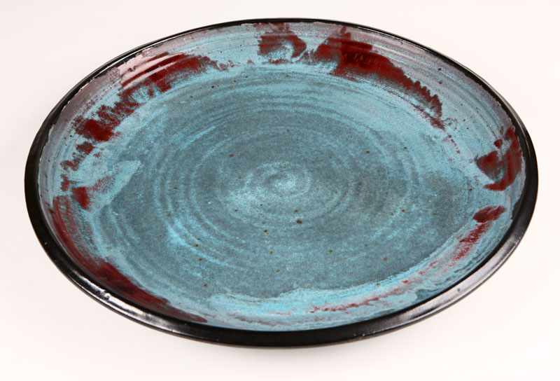 Appraisal: A large Otto Heino blue red and black-glazed stoneware charger