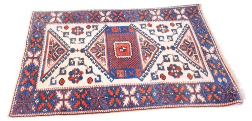 Appraisal: A Middle Eastern rug on a cream blue and red