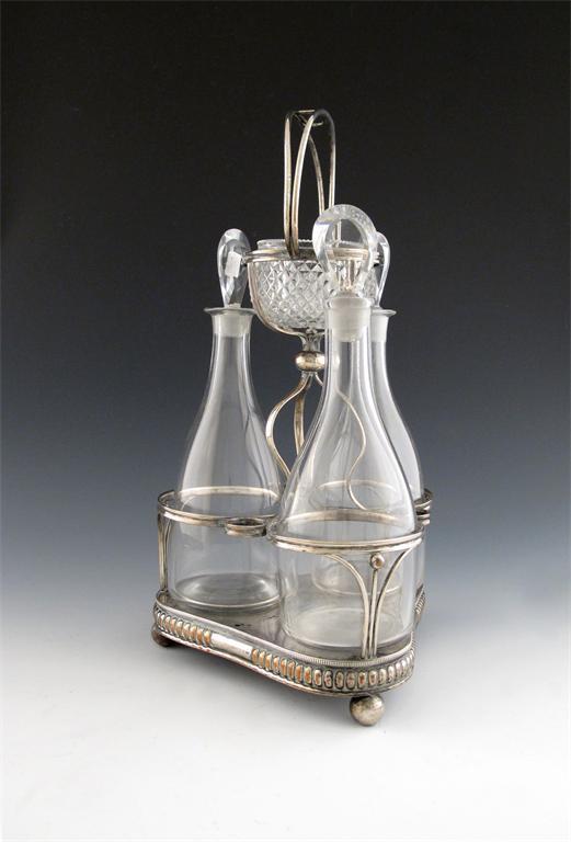 Appraisal: An early th century old Sheffield plated three-bottle decanter