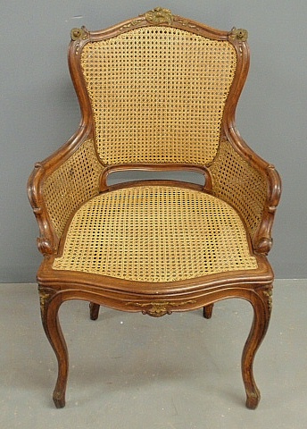 Appraisal: - French carved walnut and caned armchair h x w